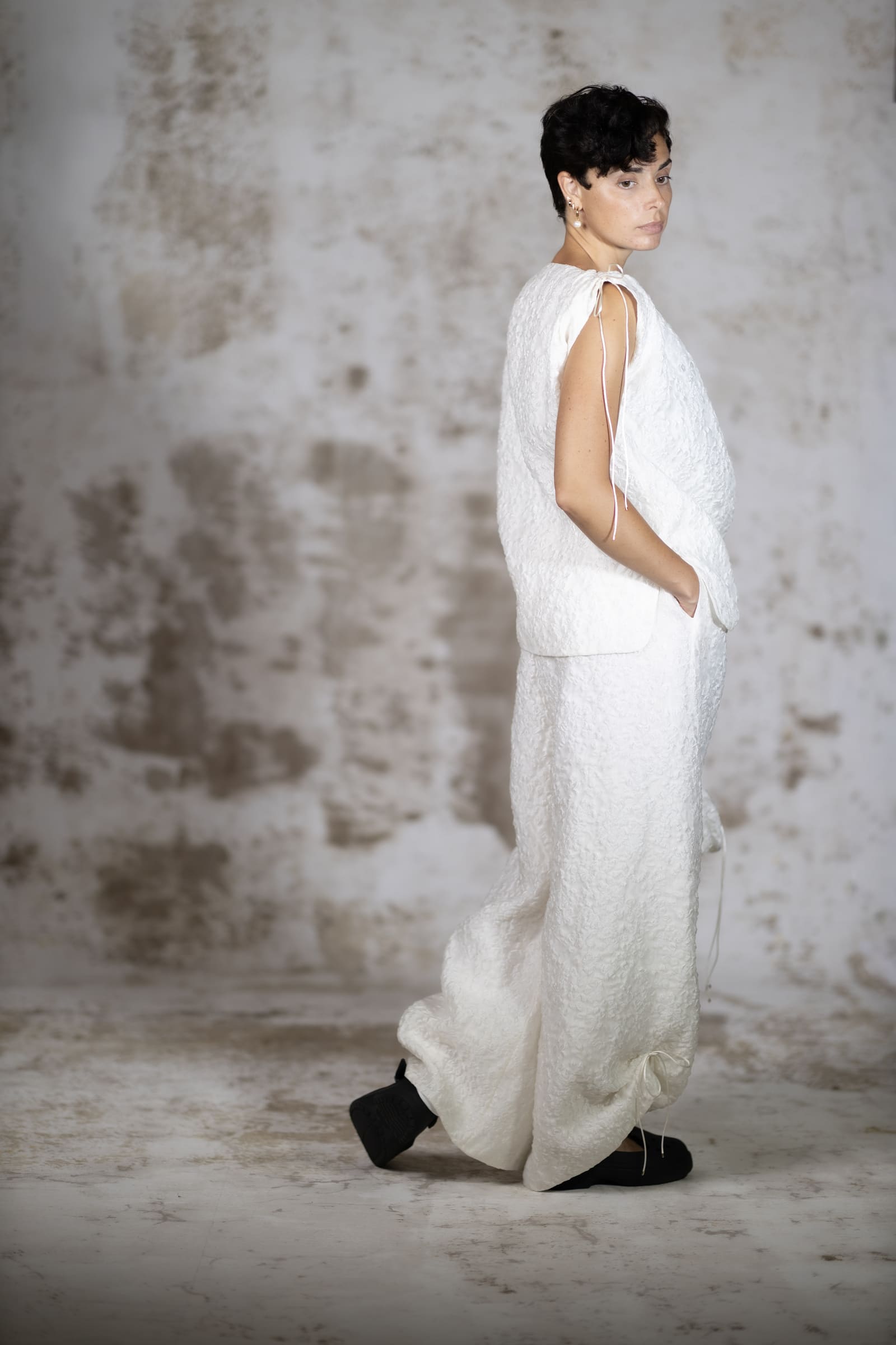 Full-body back view of the Raiola blouse, showcasing the exquisite luminous reflection and brilliant texture of the premium silk jacquard - Anabel Santos