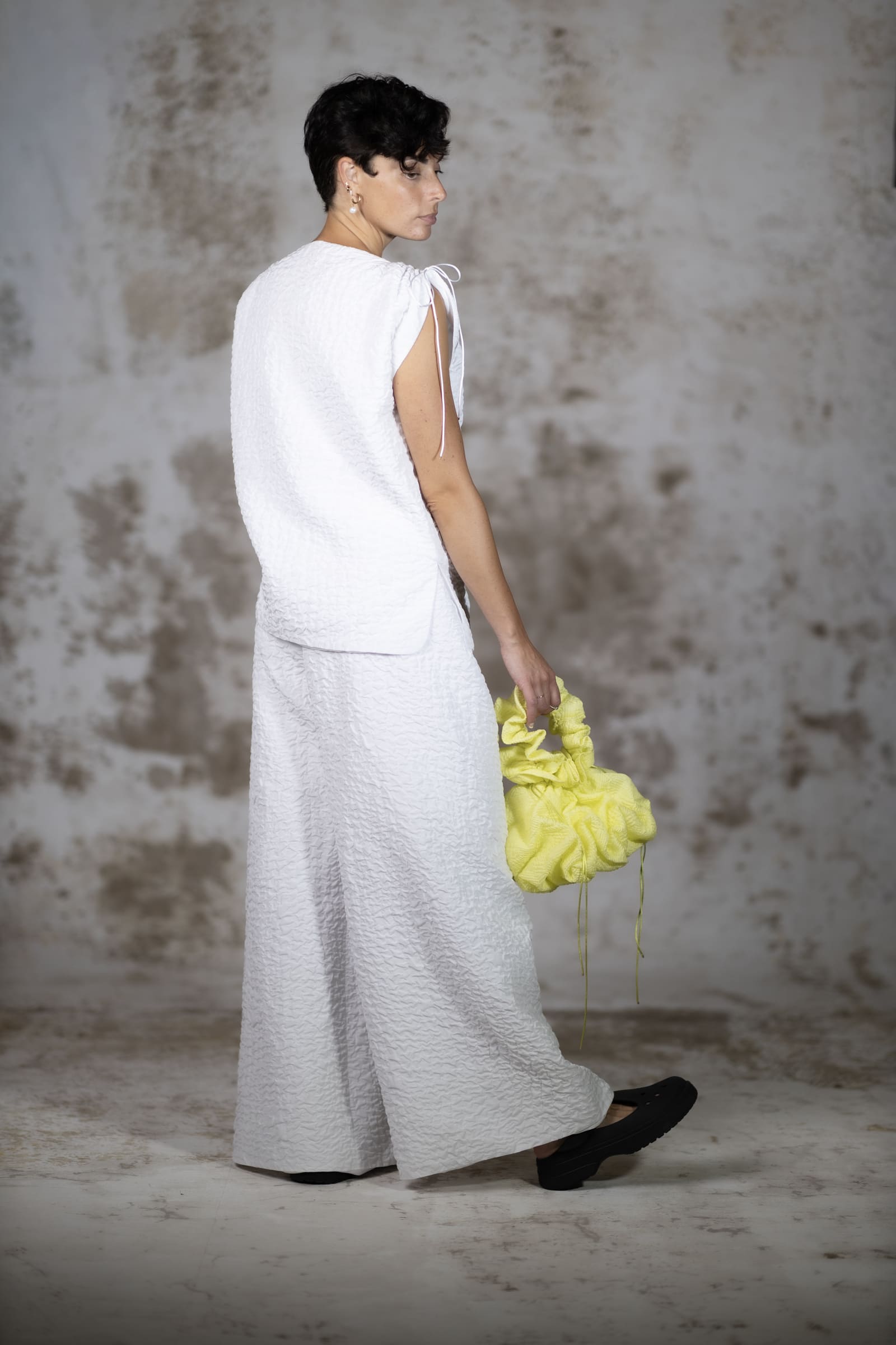 Full-body back shot of the Escuma blouse, emphasizing the structured, clean minimalist lines of the premium rich jacquard fabric - Anabel Santos