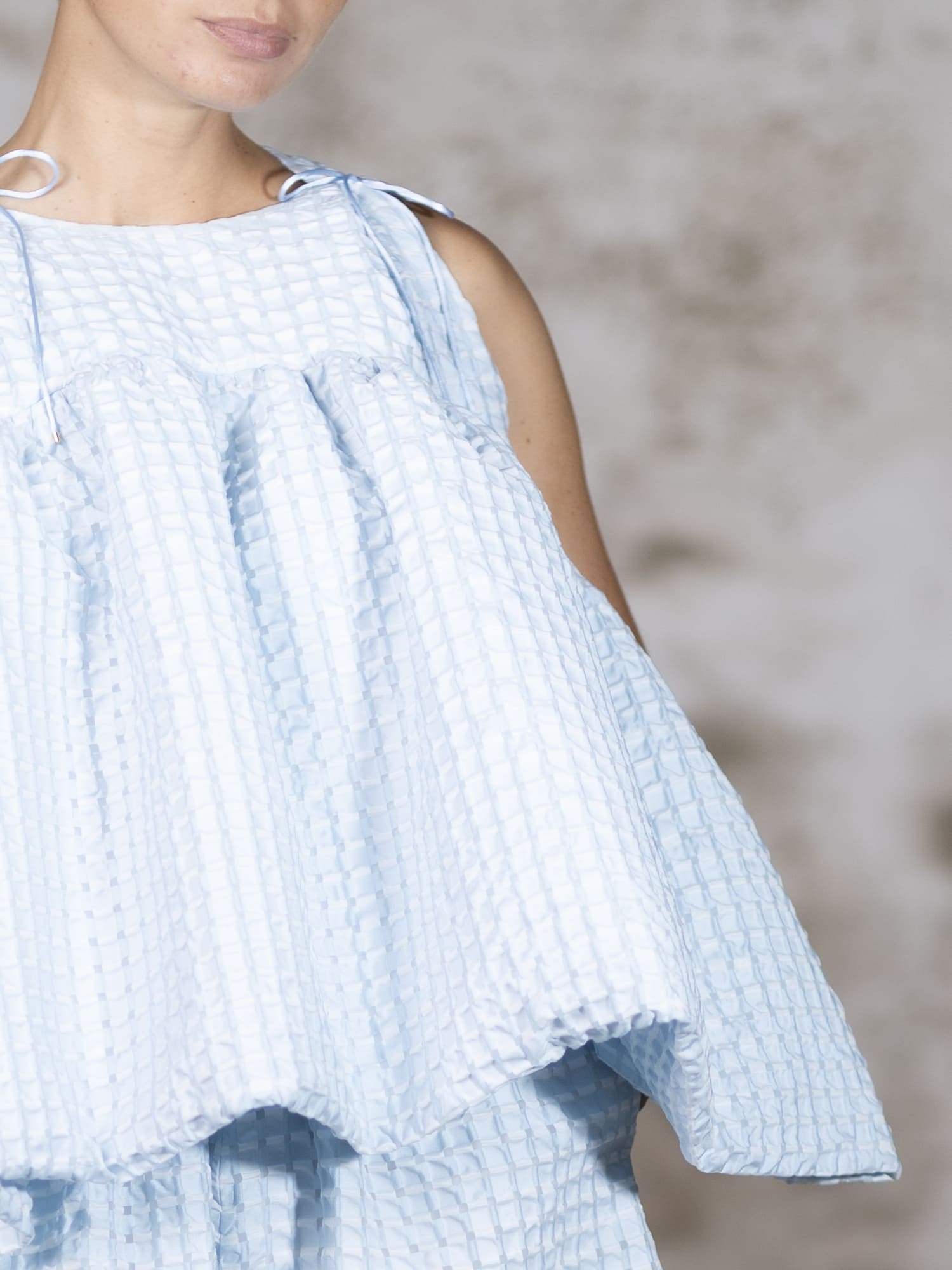 Close-up shot of the Blue Brisa blouse, focusing on the dramatic structured ruffles and the rich, exquisite texture of the Jacquard Cloqué - Anabel Santos